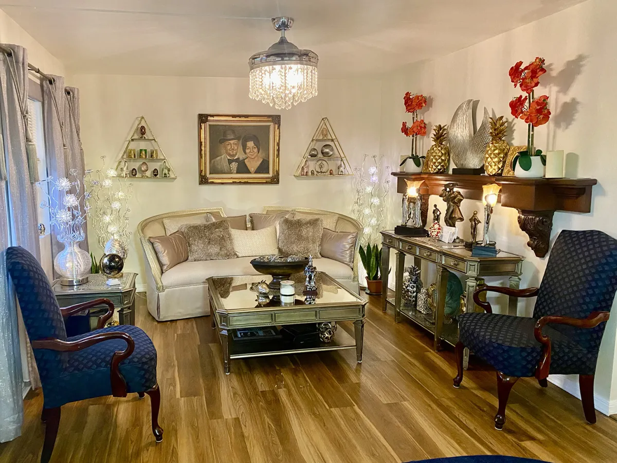 The warm, welcoming sitting room at Psychic Ames, with a crystal chandelier and a framed family portrait